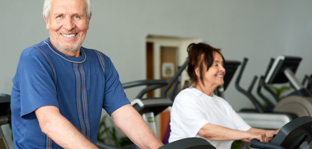 Elderly man using an exercise machine