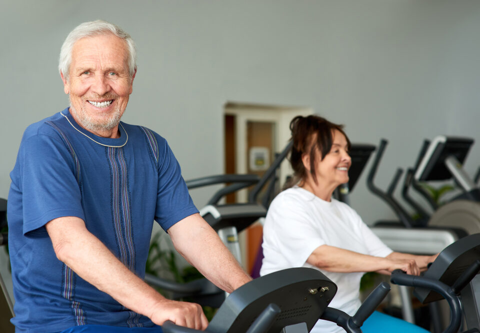 Elderly man using an exercise machine