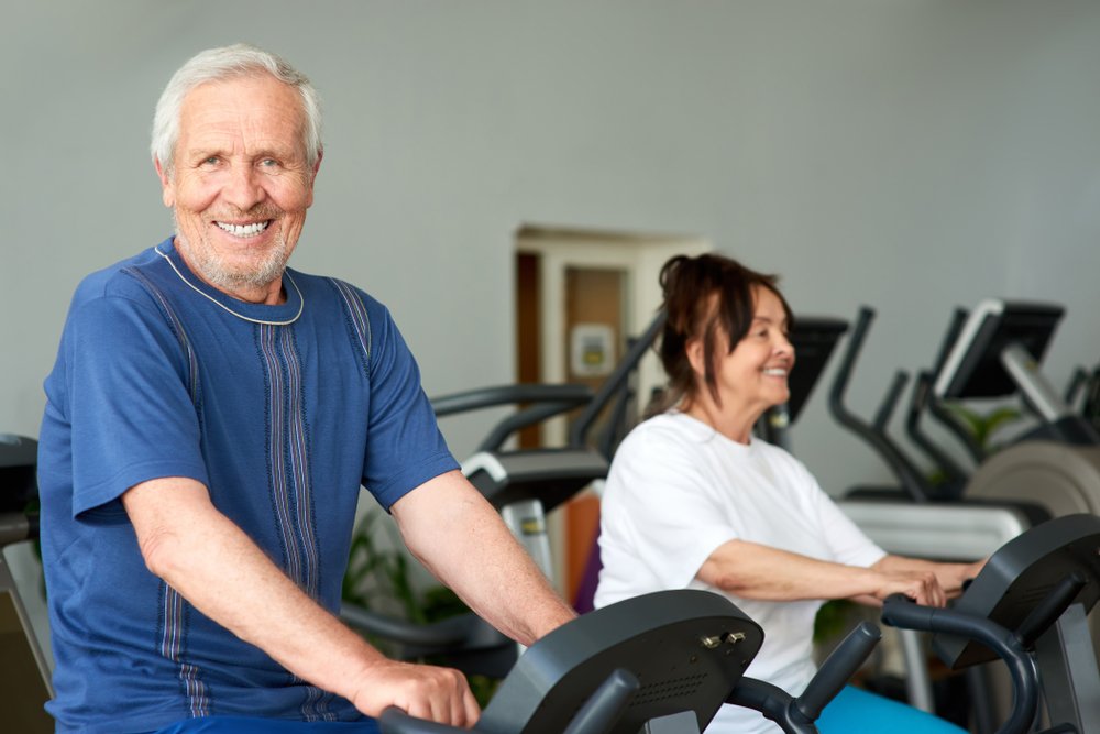 Elderly man using an exercise machine